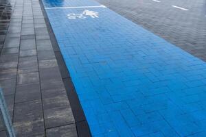 A designated accessible parking area is indicated with blue pavement and clear symbols, emphasizing inclusivity in urban design photo