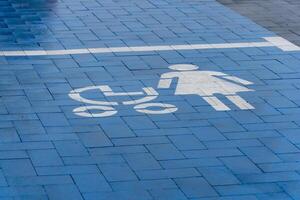 A blue marked parking space for mothers with strollers is visible, promoting accessibility for families in a busy location photo