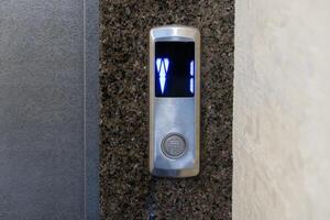 A sleek elevator panel with illuminated floor buttons fits perfectly with the apartment's modern design photo