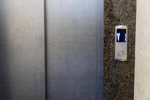 In a stylish apartment, the elevator control panel features illuminated buttons and a seamless steel design, ideal for effortless transportation photo