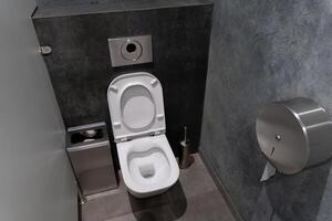 This public restroom showcases a minimalist design with a clean toilet, ensuring convenience and hygiene for users in a modern facility photo