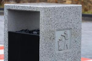 Urban area features a concrete garbage container designed for efficient waste disposal and environmental conservation practices photo