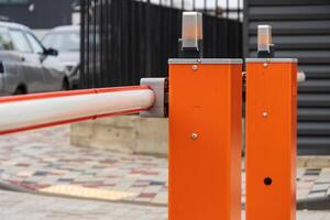 An automatic barrier is closed, controlling access to a parking lot, ensuring secure entry for authorized vehicles only photo