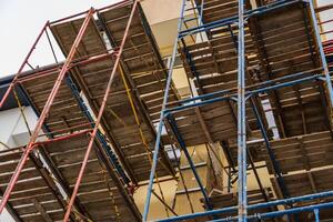 Workers rely on sturdy scaffolding to safely navigate and complete building projects at a construction site in progress photo