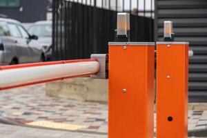Security barrier is closed, preventing entry into the parking lot, ensuring control and safety at the entrance to the facility photo