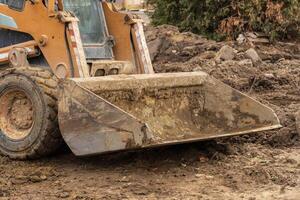 Backhoe operates at a construction site, efficiently digging and preparing the ground for new infrastructure development and engineering tasks photo