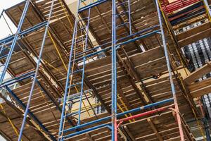 Multiple levels of scaffolding are used to support construction work, ensuring a safe environment for workers and efficient project progress photo