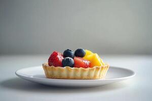Modern minimalistic food photo capturing single tart with fresh fruits on white plate, set against neutral background for sophisticated, clean aesthetic