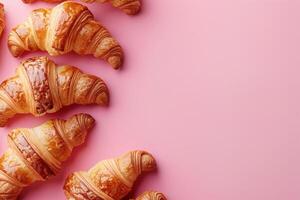 Flat lay composition featuring flaky croissants and sweet jam on soft pink surface, ideal for breakfast themed promotions and menus photo