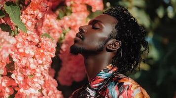 A person with eyes closed in front of pink flowers photo