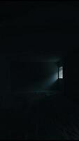A small light is turned off. The room is dark. The camera holds for several seconds. video
