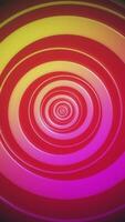 Vibrant colorful abstract background with a spiral design of swirling circles in pink, red and orange. Bright colorful tunnel effect. Full HD and looping vertical animation. video