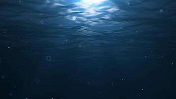 Dark Underwater with light ray and bubble particle floating background video