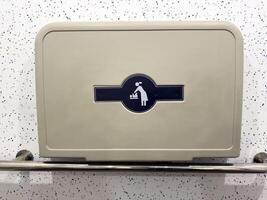 Baby changing symbol on wall mounted foldable table in public restroom. Clear icon for parents, providing visual guidance and enhancing accessibility in modern public infrastructure photo