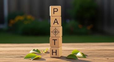 Wooden blocks spelling PATH with a compass symbol representing direction and guidance photo