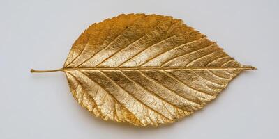 The golden leaf showcasing intricate details and stunning metallic shine. photo