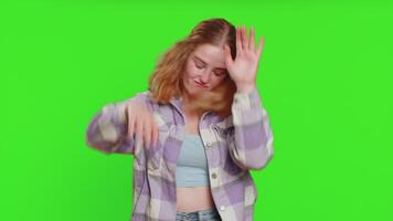 Happy smiling woman listening music and dancing disco, fooling around having fun expressive gesticulating hands relaxing on party, making funny moves. Redhead girl isolated on chroma key background video