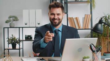 I choose you. Young Caucasian business man programmer software developer working on office laptop pointing to camera, looking with happy expression, making choice showing direction. Freelancer guy video