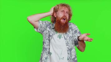 I dont know what to say. Confused bearded man feeling embarrassed about ambiguous question, having doubts, no answer idea being clueless, uncertain. Redhead guy isolated on green chroma key background video