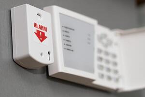 panic button of security systems on a gray wall, close-up. selective focus. photo