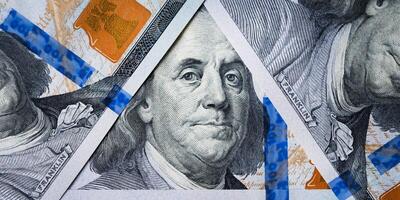 Dolar USA close up. Benjamin Franklin's eyes from a hundred-dollar bill . The texture of the fragment of the dollar bill. One hundred American dollars. photo