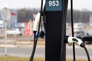 Charging station for electric vehicles to charge the battery of an electric vehicle. Plug for a car with an electric motor. charger for electric car. Clean energy. Charging point in the parking lot. photo