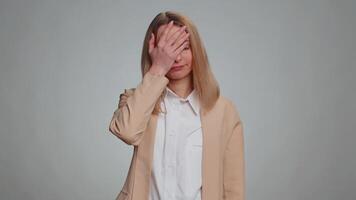 Face palm. Shame on you. Upset businesswoman making face palm gesture, feeling bored, disappointed in result, bad news. Female girl in formal suit. Pretty woman isolated on gray studio background video