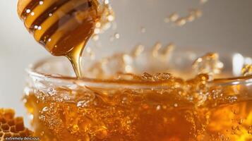 Honey dripping into a bowl captured during liquids golden flow photo