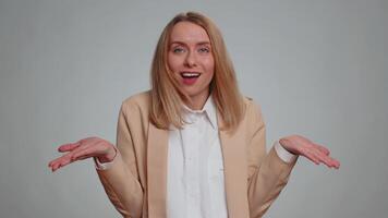 What Why. Sincere irritated business woman raising hands in indignant expression asking reason of failure demonstrating disbelief irritation by trouble. Confused girl in formal suit on gray background video