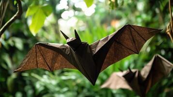Origami paper bats fly in a forest with vibrant green foliage photo