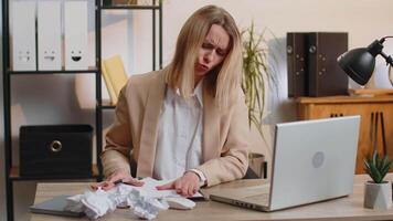 Angry furious business woman working at office throwing crumpled paper, having nervous breakdown at work, headache, stress management, mental distress problems, losing temper, reaction on failure video
