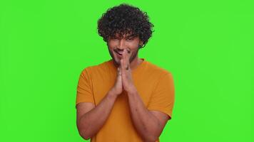 Villain idea. Sneaky young indian man conspiring scheming, thinking over tricky plan with cunning expression, pondering revenge or evil joke prank. Hindu guy isolated on green chroma key background video