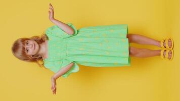What. Why. Blonde school girl raising hands in indignant expression, asking why, what reason of failure demonstrating disbelief irritation by troubles. Preteen child kid on yellow background. Vertical video