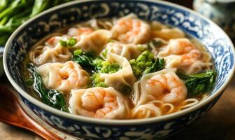 a bowl of soup with shrimp and noodles photo