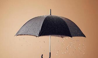 A black umbrella is opened and raining on a wall photo