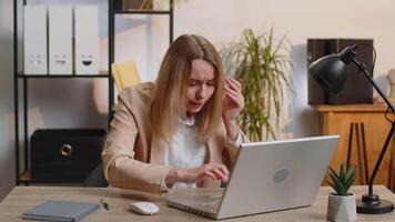 Irritated shocked young business woman while working on laptop, unexpected online website problem, computer virus data loss by hacking. Freelancer feeling mad about broken notebook at office workplace video
