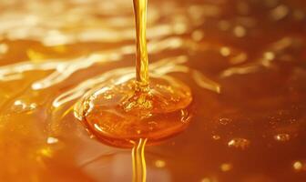 A stream of honey is pouring into a cup photo