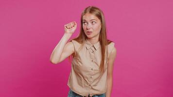 Knock-knock who is there. Excited young woman knocking door gesture asking who is at home, feeling embarrassed, no idea, being clueless and uncertain. Girl isolated alone on studio pink background video