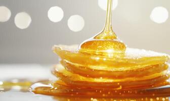 A stack of pancakes with a drizzle of honey on top photo