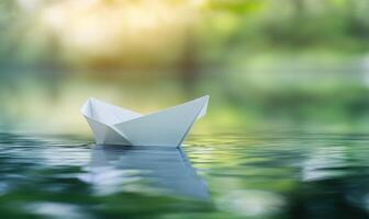 paper boat floating in the water with sunlight photo
