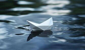 a paper boat floating in the water photo