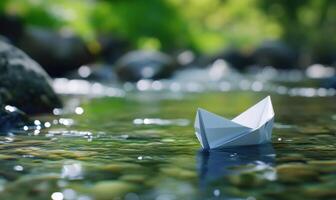 A white paper boat is floating in a river photo