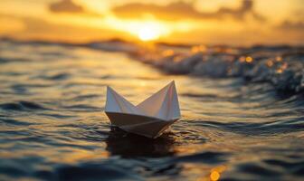 A paper boat is floating in the ocean photo