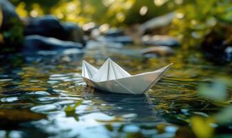 a paper boat floating in a stream photo