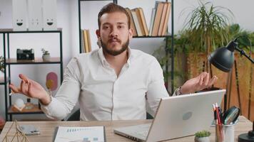 I dont know what to say. Confused business man working on laptop at office workplace. Freelancer feeling embarrassed about ambiguous question, having doubts, no answer idea, being clueless, uncertain video