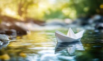 paper boat floating in the water photo