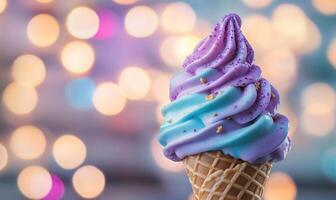 A blue and purple ice cream cone with sprinkles on top photo
