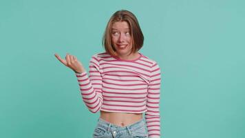 You are crazy, out of mind. Displeased woman pointing at camera, show stupid gesture finger near head, blaming some idiot for dumb insane plan idea, senseless talk. Girl isolated on blue background video