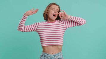 Tired exhausted young Caucasian woman yawning, sleepy inattentive feeling somnolent lazy bored gaping suffering from lack of sleep insomnia. Girl in crop top isolated on blue studio background indoors video