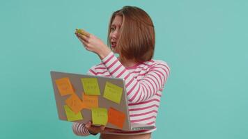 Exhausted freelancer woman with pasted sticker notes use laptop computer having concentration problem creative crisis, time out. Nervous girl confused by big routine work loading on blue background video